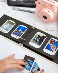 a camera and some pictures on a table