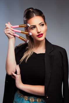 a woman with makeup brushes in her hands