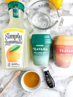 the ingredients to make an ice cream smoothie are displayed on a marble countertop