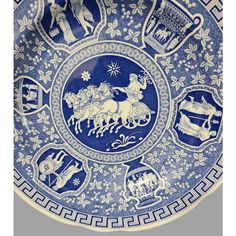 a blue and white plate with horses on it