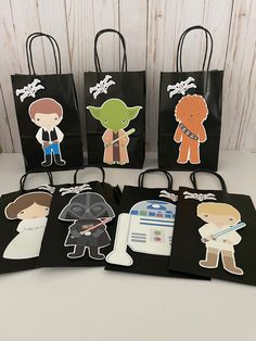 four star wars bags with the characters on them