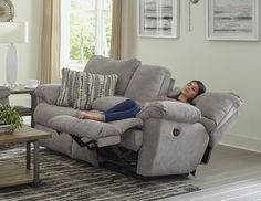 a woman laying on the couch in her living room