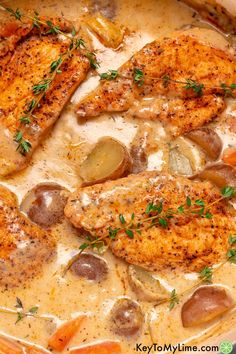 chicken and potatoes in a creamy sauce with fresh herbs on top, ready to be eaten