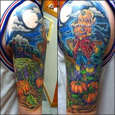 a man with a full sleeve tattoo on his arm and shoulder is holding a pumpkin