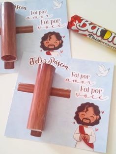 two wooden crucifixs with stickers on them, one for jesus and the other for love