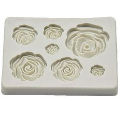 four roses shaped chocolate molds on a white background