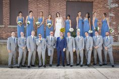 a group of people in suits and ties posing for a photo