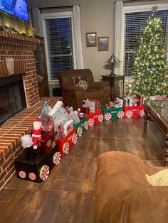 a living room decorated for christmas with presents on the floor