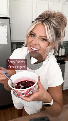 a woman holding a bowl of food in her hands