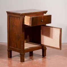 a small wooden table with an open drawer