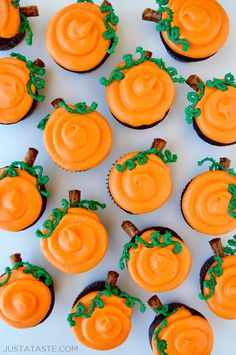 cupcakes decorated with orange frosting and green leaves