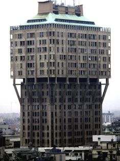 a very tall building with lots of windows on it's side in black and white