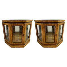 a pair of glass and wood side tables