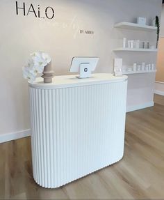 the front desk of a hair salon with flowers on it