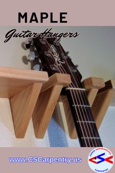 a guitar hanging from the side of a wall with text overlay that reads maple guitar hangers