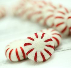 two red and white candy canes laying on top of each other