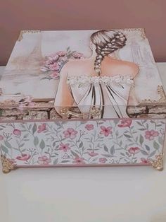 a decorative box with an image of a woman's dress on the front and side