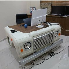 an old fashioned computer is sitting on a desk in the middle of a white room