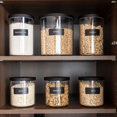 the shelves are filled with different types of cereals and other food in plastic containers