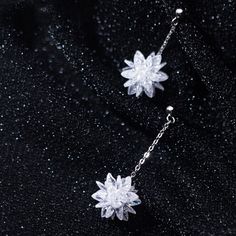 This pair of snow flower dangle drop earrings features a beautiful snowflake / lotus flower in white crystal with dangle chain made of solid 925 sterling silver with platinum platting. Add this pair of white flower dangle drop earrings to your everyday fine jewelry collection or as gift for your love one this Christmas holiday season. Jewelry Care: See more information about how to care for your jewelry here. Shipping Policy: Orders will be shipped within 1-3 business days. Economy shipping will Winter Inspired Jewelry, Silver Crystal Flower Earrings For Gift, White Sterling Silver Flower Earrings For Party, Silver Crystal Flower-shaped Earrings, Snow Jewelry, Snow Earrings, Christmas Gift Earrings, Snowflake Jewelry, Snow Flower