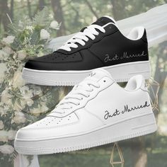 two black and white shoes with the words get married written on them next to flowers