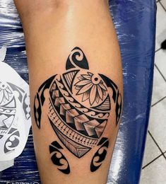 a black and white tattoo on the leg of a person with an intricate turtle design