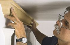 a man is working on a piece of wood