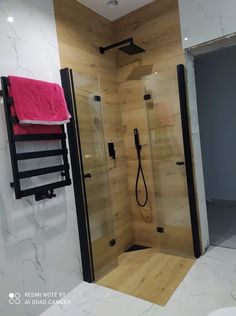 a bathroom with a stand up shower next to a toilet