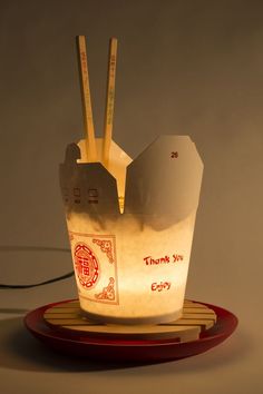 a light that is sitting on top of a plate with chopsticks in it