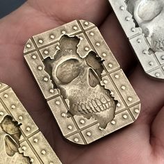 three pieces of metal that have been made to look like skulls