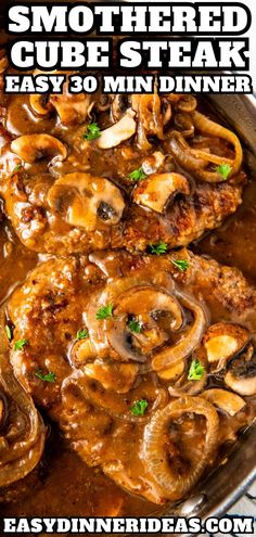 a pan filled with meat and mushrooms covered in gravy on top of a table