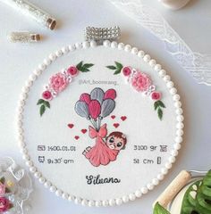 a cross stitch ornament featuring a girl with balloons and flowers in the hoop