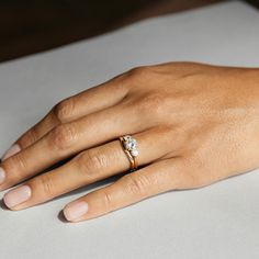 a woman's hand with a diamond ring on it