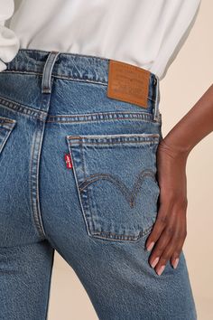 The most stylish 'fits call for a tried and true classic like the Levi's Wedgie Bootcut Medium Wash High-Rise Denim Jeans! Ever-so-slightly stretchy cotton-blend denim (in Levi's Fair Point wash) shapes these timeless jeans that feature a high-rise waist with belt loops, a five-pocket cut, and a branded top button above a hidden button fly. Vintage-inspired bootcut legs boast fading and whiskering for a lived-in effect, before finishing at subtly flared, ankle-length distressed hems. Iconic red Fitted Rigid Denim Cropped Jeans Casual, Casual Fitted Cropped Jeans In Rigid Denim, Fitted Casual Cropped Rigid Denim Jeans, Fitted Cropped Jeans For Everyday, Classic Fitted Denim Jeans, Fitted Dark Wash Cropped Jeans For Everyday, Fitted Cropped Jeans In Dark Wash For Everyday, Classic Fitted Rigid Denim Jeans, Classic Medium Wash Bottoms With Standard Cut Leg