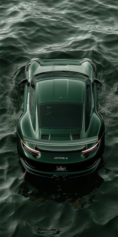 a green sports car is in the water