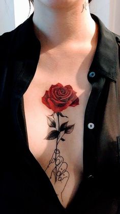 a woman with a rose tattoo on her chest