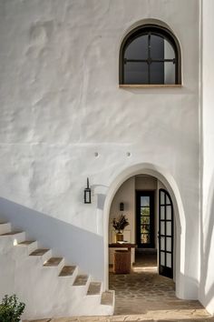 an entrance to a white house with stairs