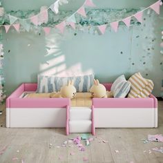 two stuffed animals sitting on top of a bed in a room with confetti and streamers