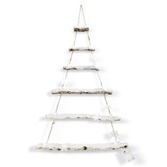 a wooden christmas tree hanging from a rope with snow on the bottom and branches attached to it