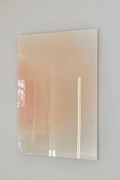 a mirror reflecting a room with white walls