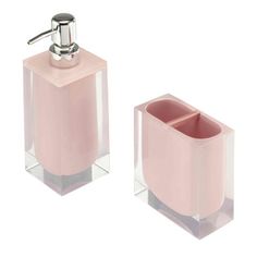 two pink soap dispensers sitting next to each other on a white background