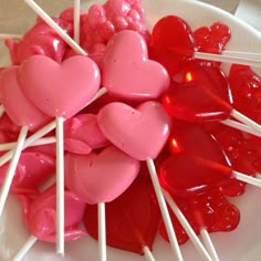 heart shaped lollipops on a plate with toothpicks in the middle