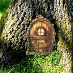 a tree stump with a small wooden door on it