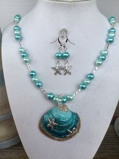 a necklace and earring set with blue beads on a mannequin neckline