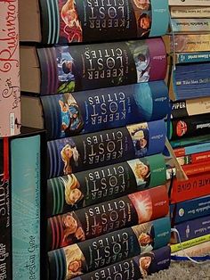 a stack of books sitting on top of a carpeted floor next to each other