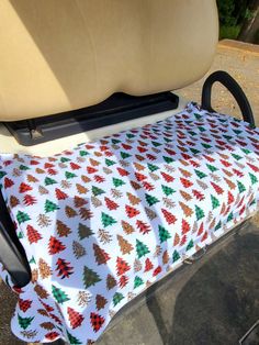 a golf cart seat cover with christmas trees on it