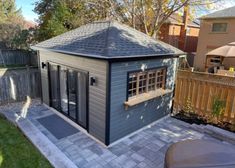 a backyard with a small shed in the middle