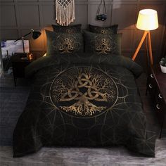 a bed covered in a black and gold comforter