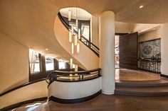 a spiral staircase in a modern home with wood flooring