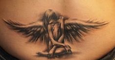 a woman's stomach with an angel tattoo on her belly and the bottom part of her abdomen